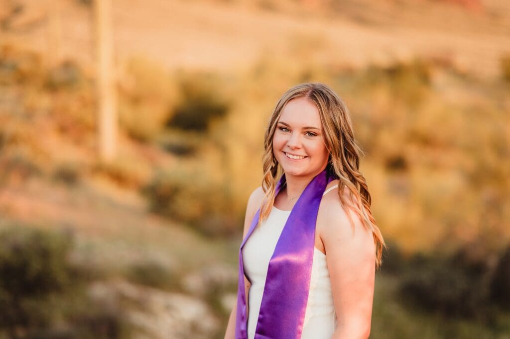 college graduate photos in the desert at sunset