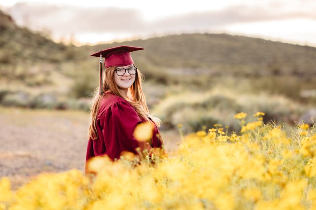 senior girl in a field of yellow wildflowers in Arizona