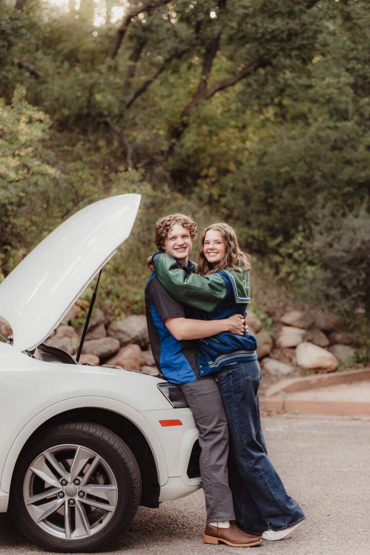 high school senior couples photos with a nice car