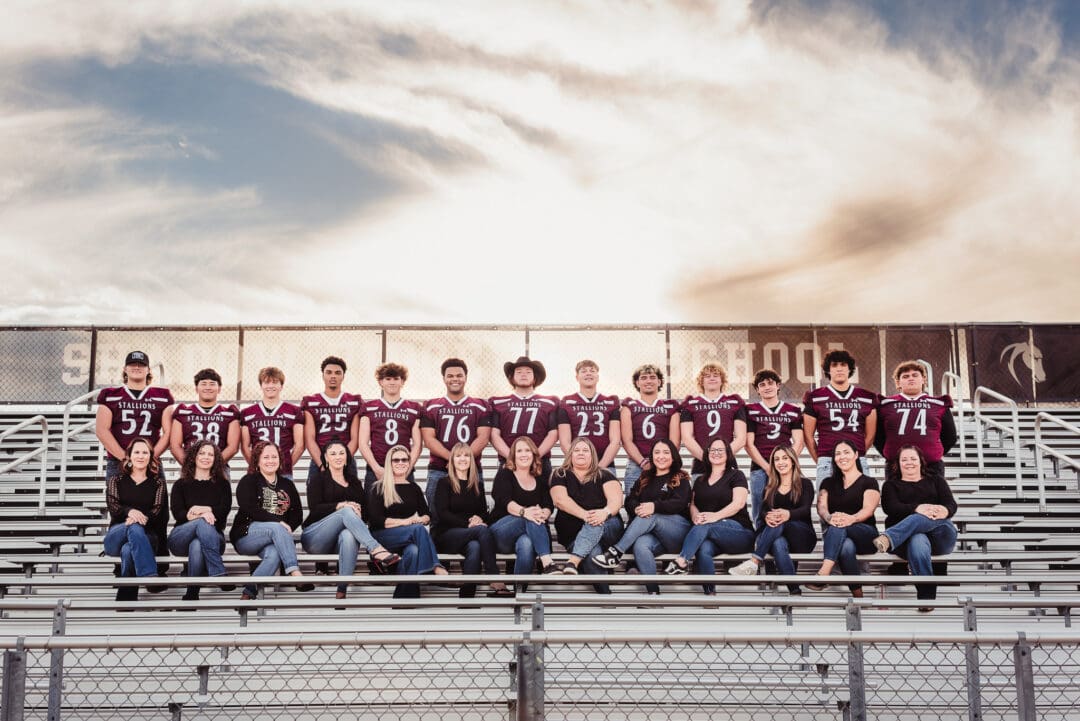 group photo for senior football moms in the stadium