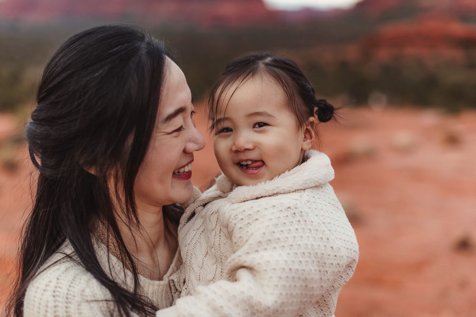 mom and toddler girl poses for family photos