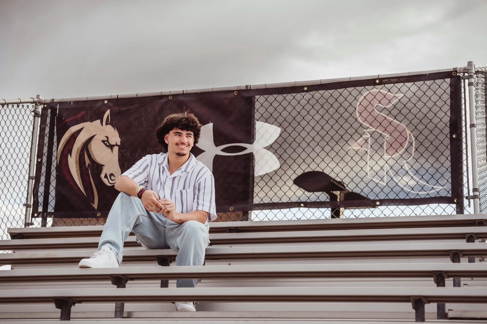senior boy photos in the football stadium bleachers