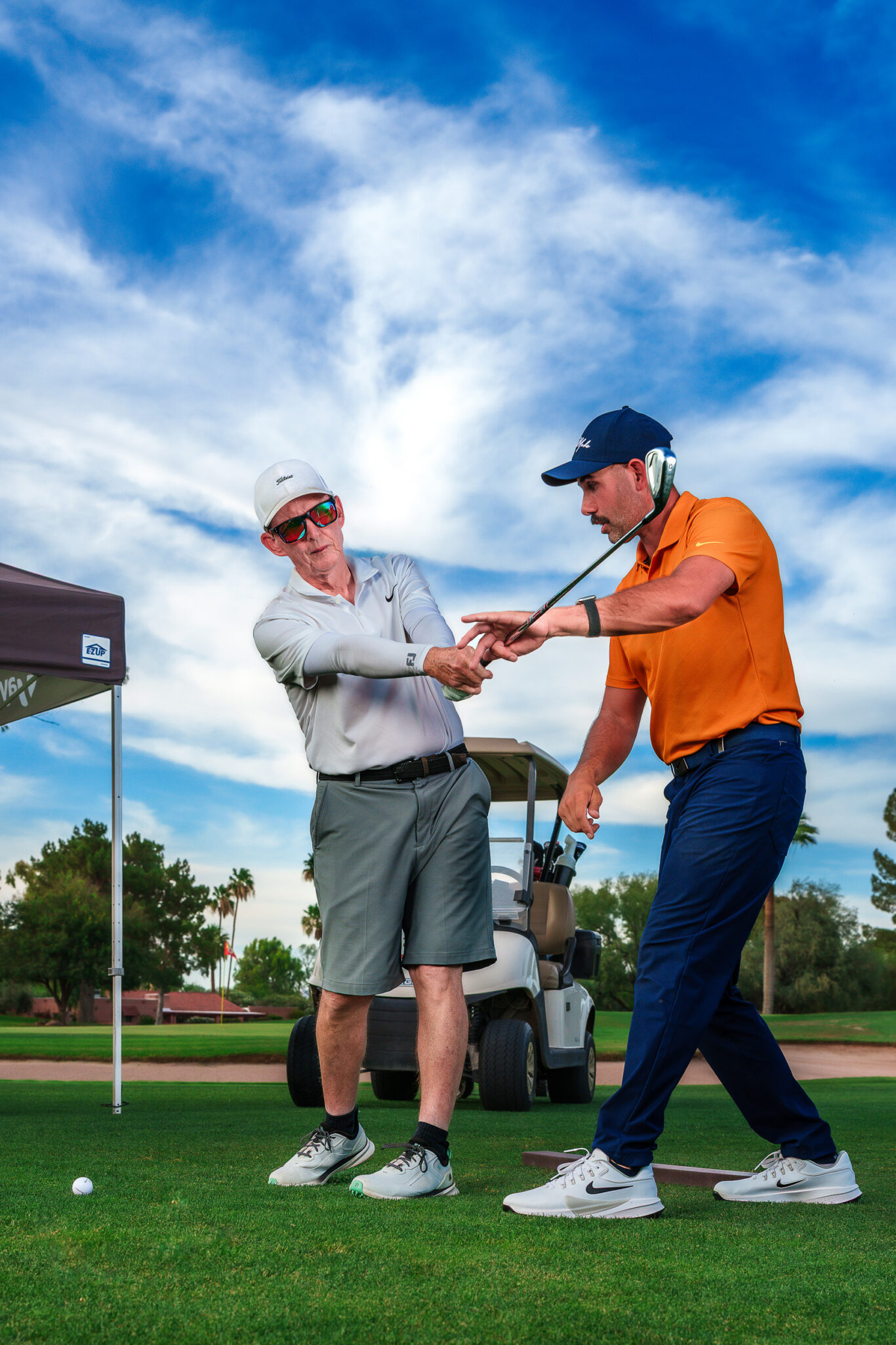 golf pro Cody M Ceccato showing golf student how to swing the club