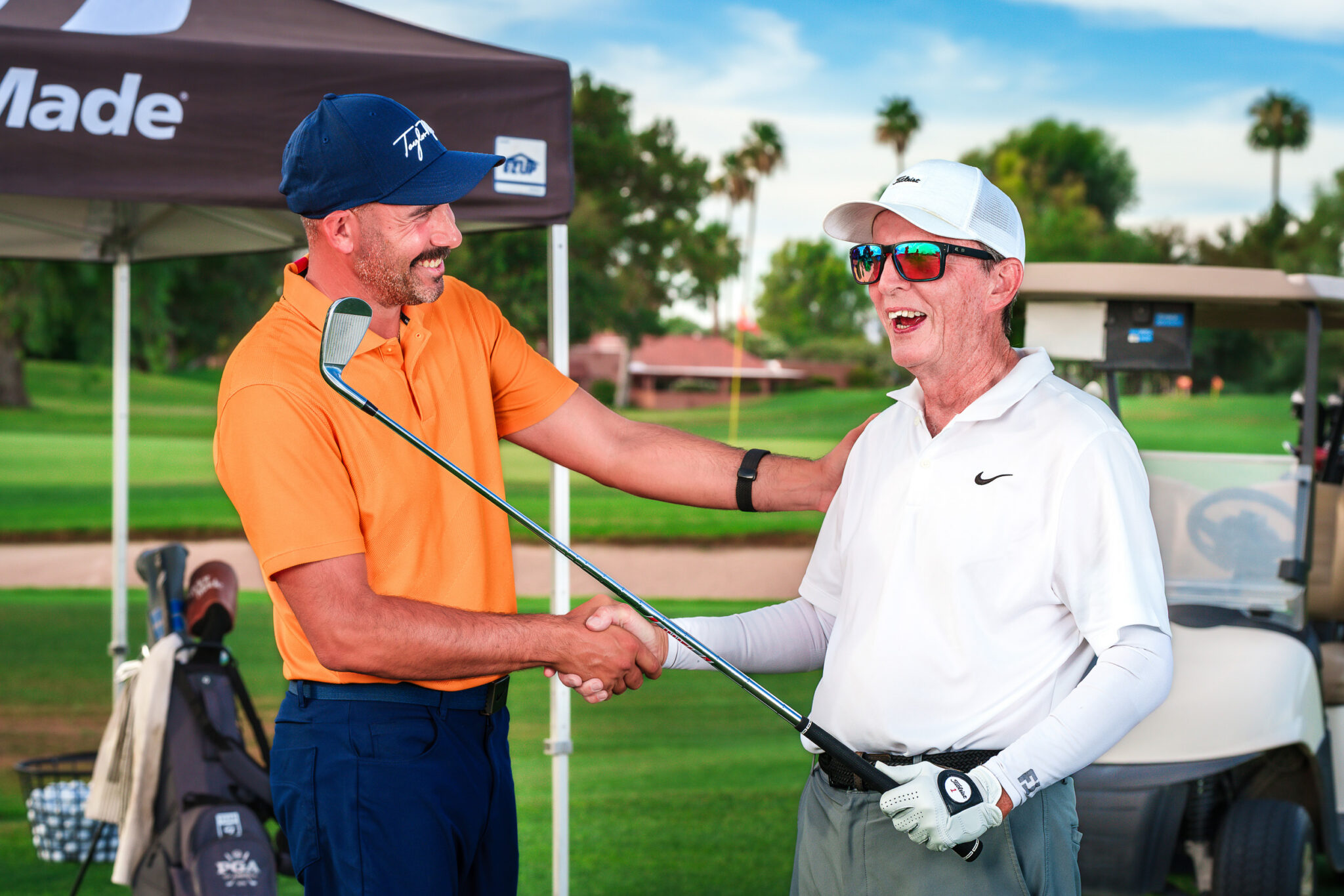 golf pro shaking hands with student golfer
