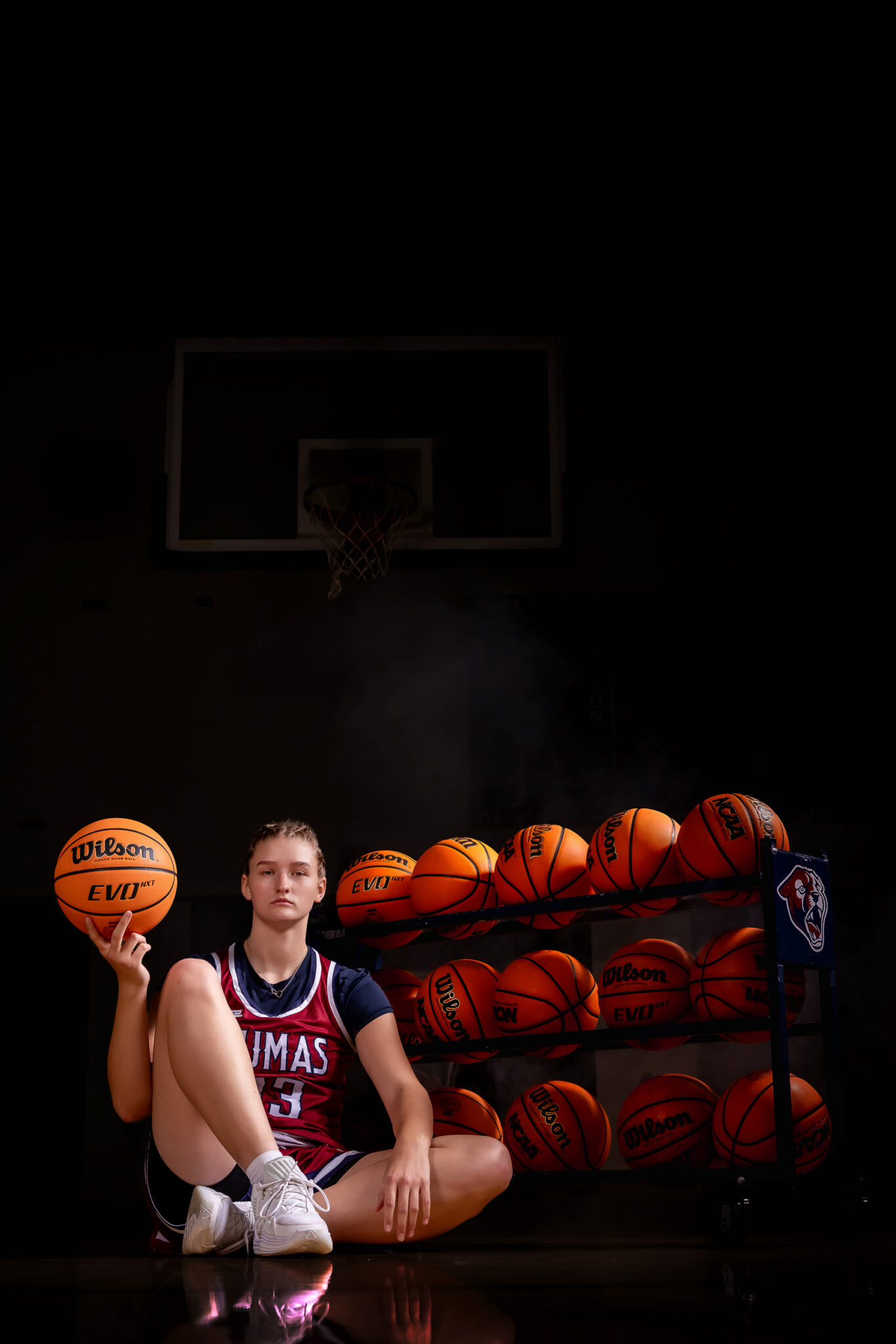 girls basketball sports portrait with basketball cart spinning a basketball on her finger